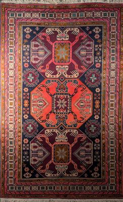 a red and blue rug with an ornate design on it