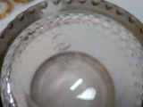 a silver bowl with a gold rim on a white table
