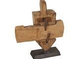 a wooden sculpture of a cross on a stand