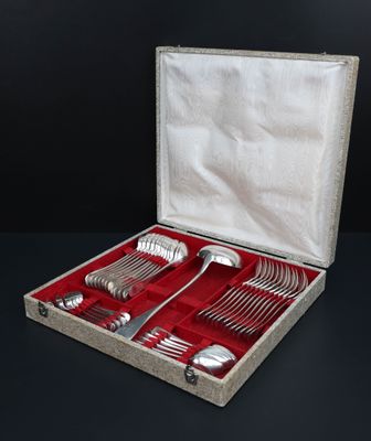 a box with silverware in it on a black surface