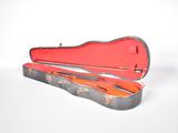 a guitar case that is open on a white surface