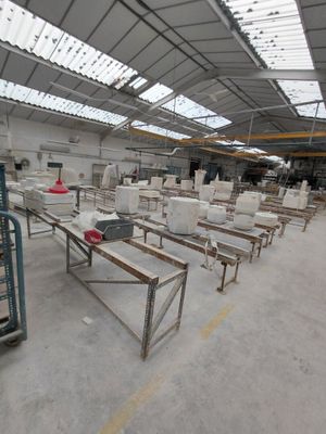 many tables and benches in a large warehouse
