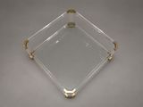 a clear glass tray with gold handles and handles