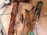 three crosses on the floor next to a wooden crucifix