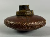 a brown vase with a brown design on it
