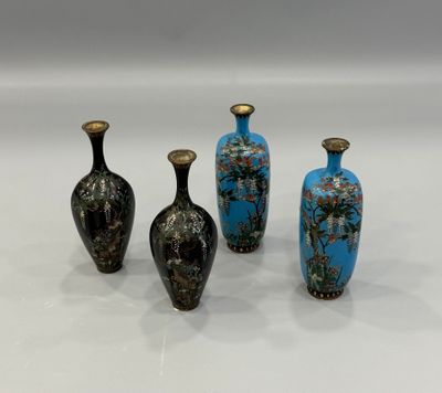 three vases are sitting on a white surface, one has blue and the other has gold
