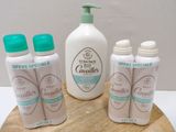 several bottles of lotion sitting on top of a wooden board