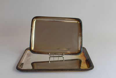 a silver tray with a mirror on top of it