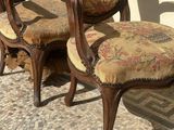 two chairs sitting next to each other on a brick floor