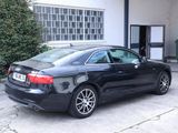 a black car parked in front of a building