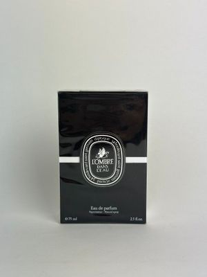 black and white box of perfume sitting on a white surface