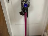 a vacuum that is sitting on the floor next to a door