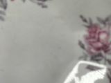 a white plate with pink flowers on it on a table