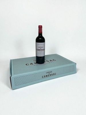 a bottle of wine sitting on top of a blue box