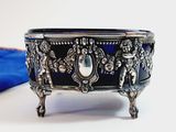 a silver and blue bowl sitting on a table