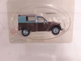 a brown and blue toy car in a clear display case