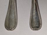 two spoons that are sitting on a table
