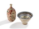 a small vase and a small bowl sitting next to each other