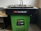 a green trash can next to a sink in a room
