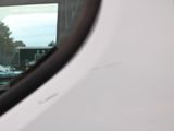 a reflection of a car in the side mirror of a white van