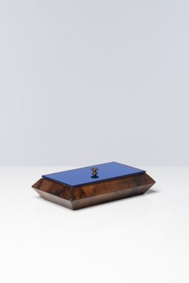 a small wooden box with a blue lid sitting on top of a white table