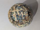 a close up of a bowl with a mosaic design on it