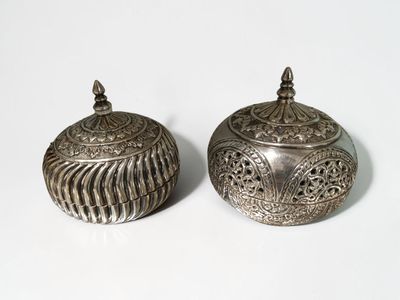 pair of antique silver plated sugar and butter pots on a white surface