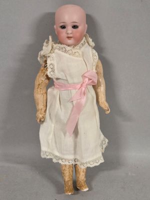 a small doll with a pink bow on it ' s head