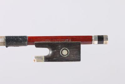 the bow is made of wood and has a red handle