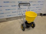 the yellow bucket is sitting on the cart in the room