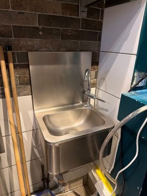 a sink in the corner of a bathroom being remodeled
