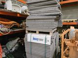 a pile of metal sheets stacked on top of each other in a warehouse