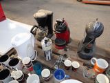 many cups and a coffee maker on a pallet