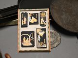 a small box with four cards in it on a table