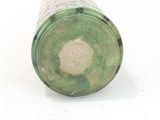 underside view of a green and white vase on a white surface