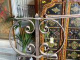 a potted plant on a stand in front of a cabinet