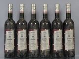 six bottles of wine sitting on top of a table next to each other