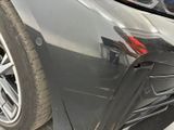a close up of a car ' s front bumper with a denting on it