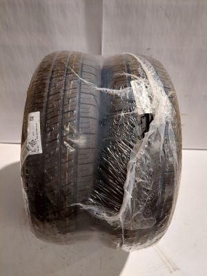 a tire wrapped in plastic on a white surface
