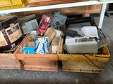 a wooden box filled with assorted items on the floor