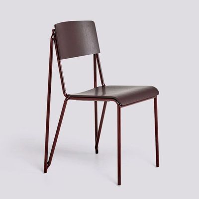 the chair is made of wood and has a brown leather seat