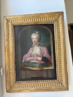 a painting of a woman sitting at a table with a cat in her lap
