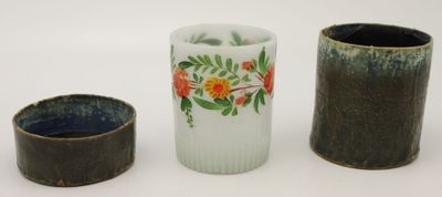 trois vases posés l'un à côté de l'autre sur une surface blanche