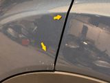yellow arrows on the side of a gray car