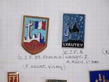 many badges on a piece of paper on the wall