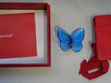 a red box with a blue butterfly inside of it