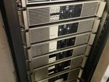 a rack of electronic equipment in the corner of a room