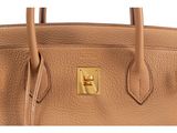 a close up of a tan leather handbag on a white background