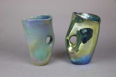 two vases sitting next to each other on a table