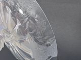 a clear glass vase with a floral design on it